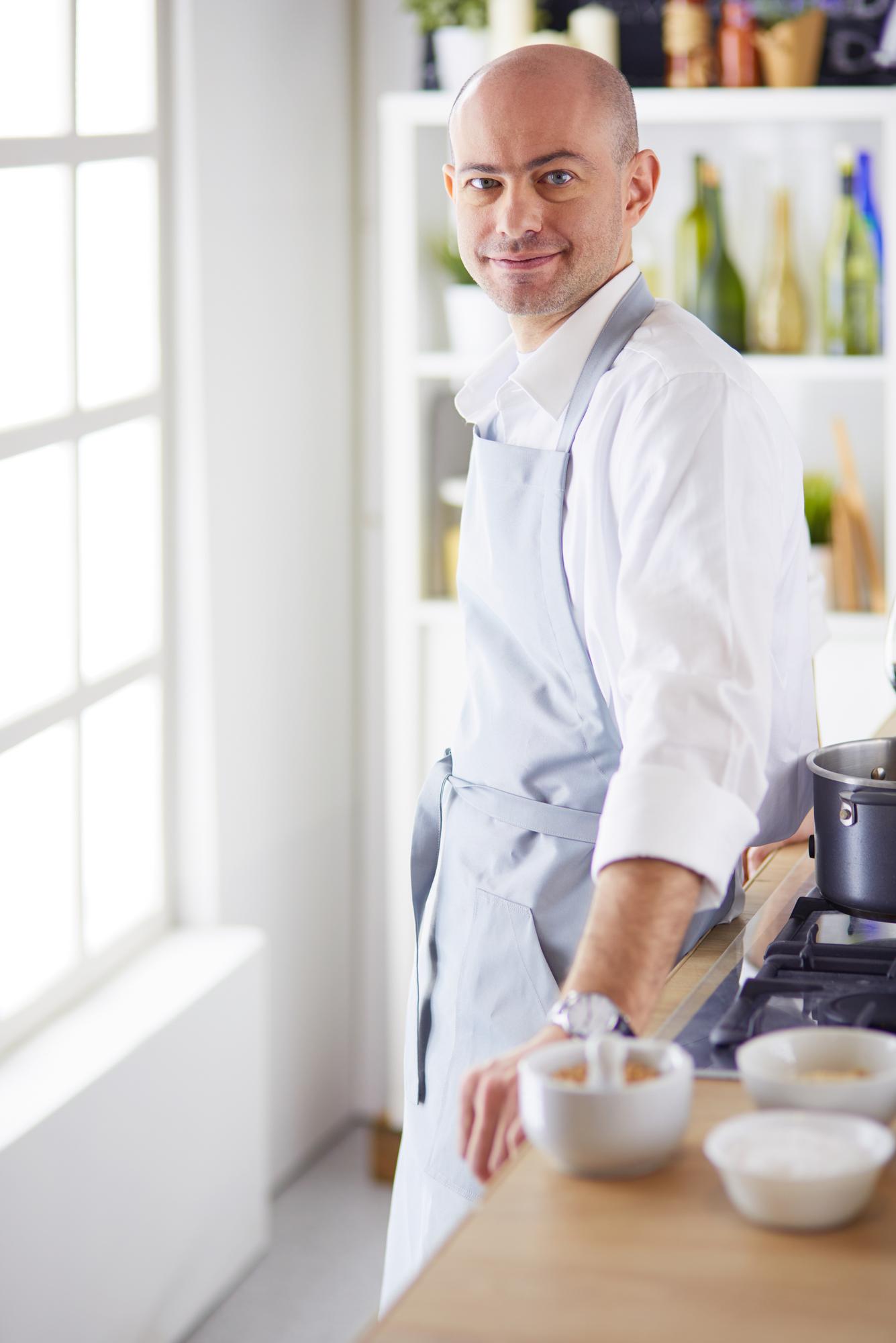Portrait of sous-chef smiling in kitchen